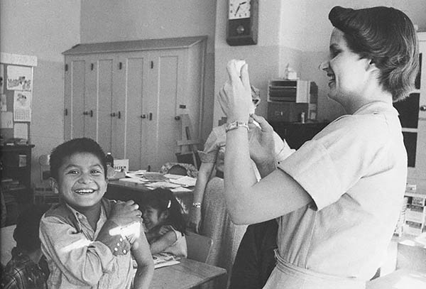 Vintage image of boy with nurse getting vaccine